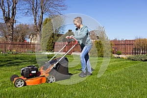 Teenage girl mowing grass