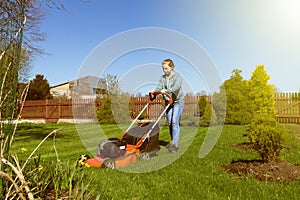 Teenage girl mowing grass