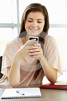 Teenage girl with phone in class