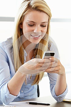 Teenage girl with phone in class