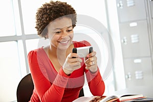 Teenage girl with phone in class