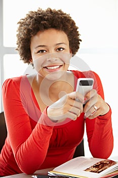 Teenage girl with phone in class