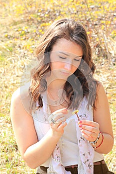 Teenage girl picking flower petals, shiny springtime scenery out