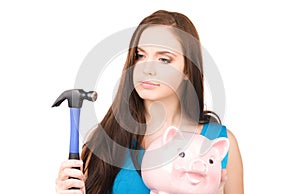 Teenage girl with piggy bank and hammer