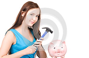 Teenage girl with piggy bank and hammer