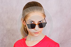 A teenage girl in the pinhole glasses.Studio shot