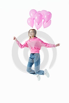 Teenage girl with pink balloons jumping isolated on white