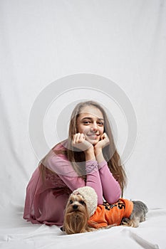 Teenage girl in pink with yorkshire terier