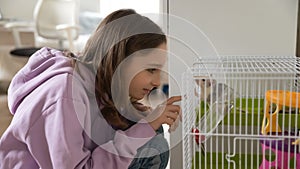 Teenage girl play with cute domesticated mouse at home photo