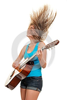 Teenage girl playing an acoustic guitar