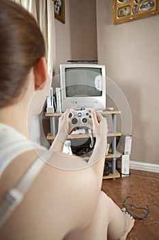 Teenage girl playing on a console game