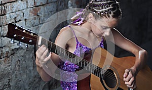 Teenage girl playing guitar