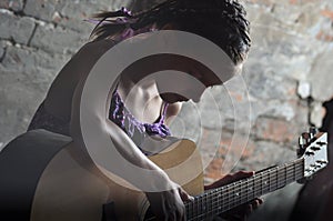 Teenage girl playing guitar