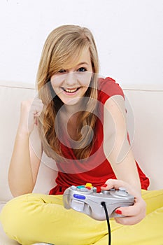 Teenage girl playing playstation photo