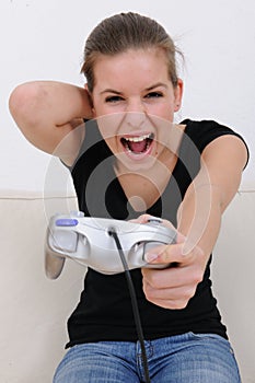 Teenage girl playing playstation photo