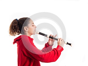 Teenage girl playing a recorder or flute photo