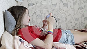 a teenage girl plays online games on a smartphone