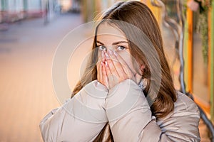 teenage girl portrait feel cold outdoor. teenage girl portrait wearing hat.