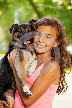 Teenage girl portrait in hugging little dog