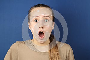 Teenage girl portrays emotion of amazement in the studio