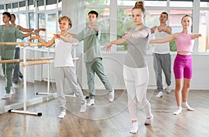 Teenage girl practicing ballet positions in dance studio