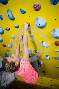 Teenage girl practicing rock climbing