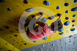 Teenage girl practicing rock climbing