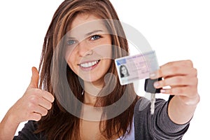 Teenage girl proudly showing driver licence