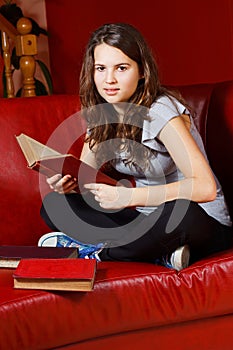 Teenage girl reading at home