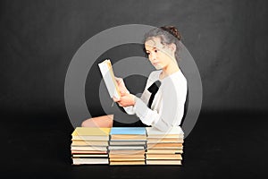 Teenage girl reading an old book
