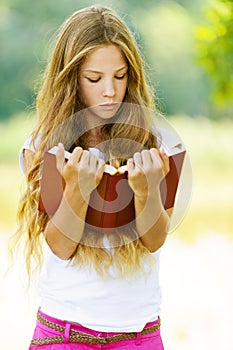 Teenage girl reading red book