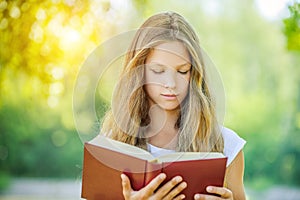 Teenage girl reading red book