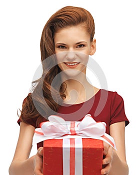 Teenage girl in red dress with gift box