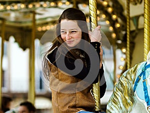 Teenage girl riding on carusel in Saverne,