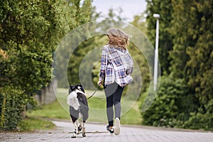 Teenage girl running with her dog