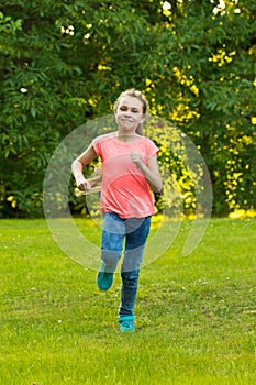 Teenage girl runs in the garden