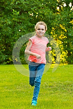 Teenage girl runs in the garden