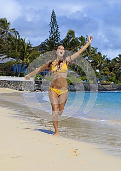 Teenage girl runs on lanikai beach