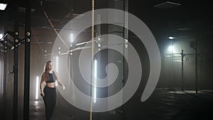 teenage girl in school gym in sporty class, doing pull-up on crossbar, physical activity for youth