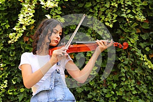 Teenage girl playing violin outdoor