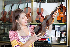 Teenage girl selecting classical violin