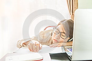 Teenage girl short hair sleep on desk after working