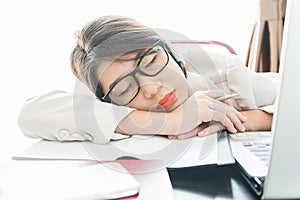 Teenage girl short hair sleep on desk after working