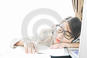 Teenage girl short hair sleep on desk after working