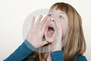 Teenage Girl Shouting With Hands Cupped Around Mouth