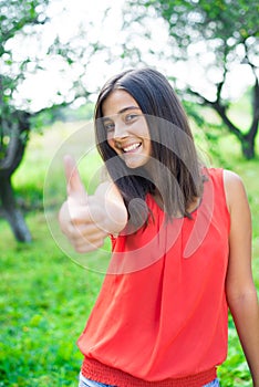 Teenage girl showing thumb up