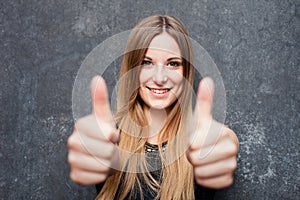 Teenage girl showing thumbs up