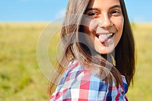 Teenage girl showing tongue