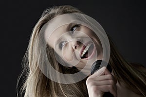 Teenage Girl Singing Into Microphone