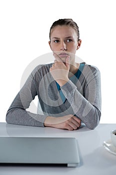 Teenage girl sitting against white background